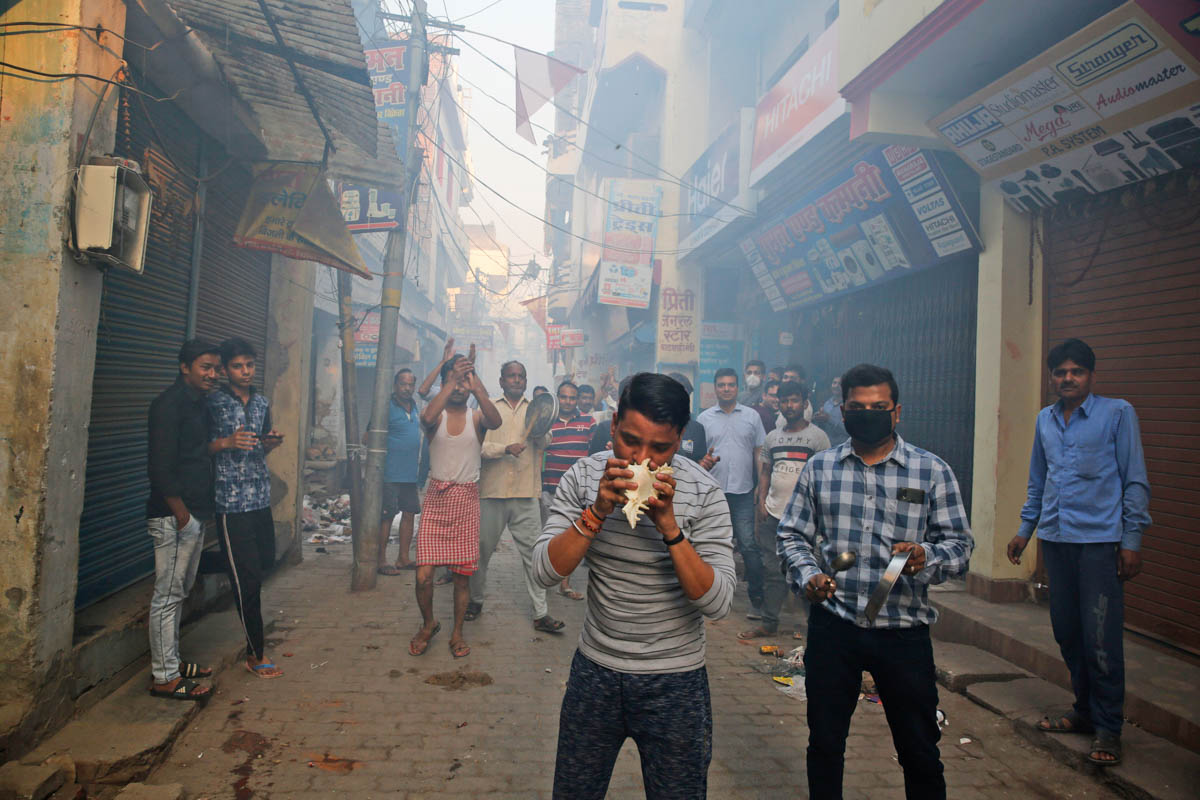 Indians bang pans, blow con shells and claps in show of appreciation to health care workers in Prayagraj, India, Sunday, March 22, 2020. India is observing a 14-hour "people''s curfew" called by Prime