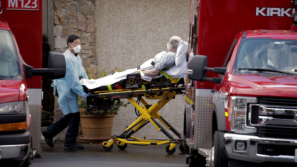 Medics transport a man on a stretcher into an ambulance at the Life Care Center of Kirkland, a long-term care facility linked to several confirmed coronavirus cases, in Kirkland, Washington, US