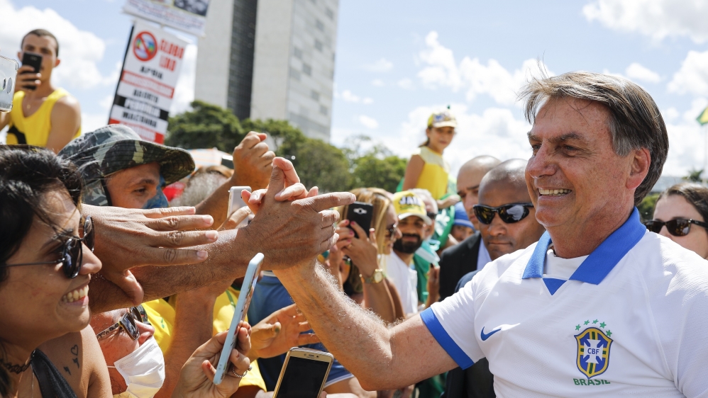 Brazilian President Jair Bolsonaro bolted out from his reported isolation on Sunday to greet supporters in Brasilia defying health experts’ recommendations on social distancing