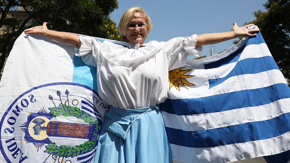 A supporter of Uruguay’s new President Luis Lacalle Pou, displays a flag outside Congress in Montevideo, Uruguay