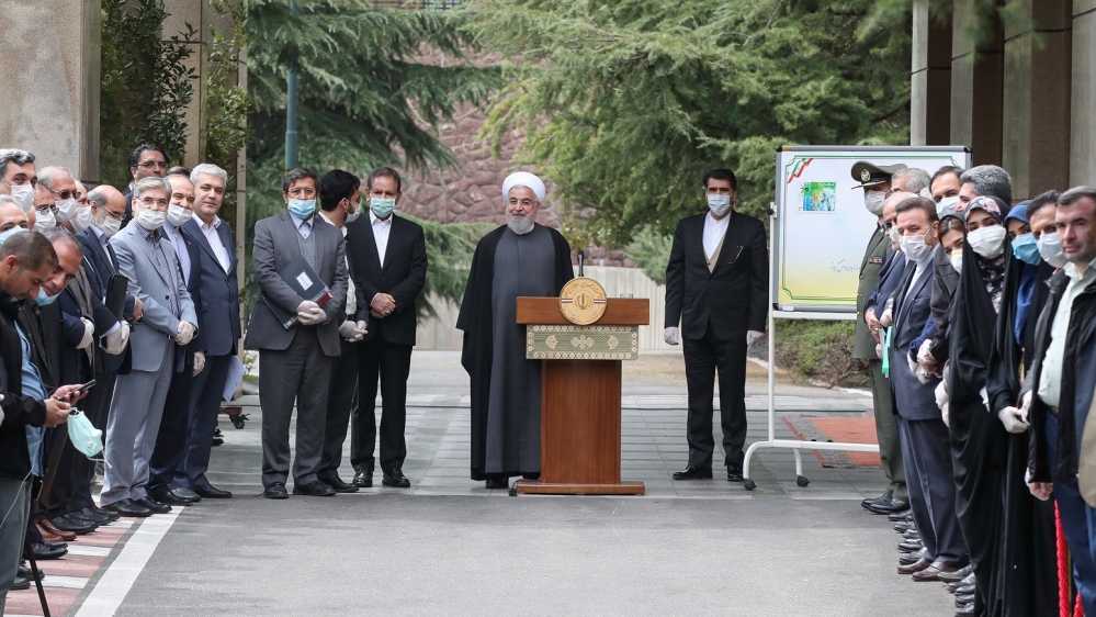 Rouhani, centre, is joined by his cabinet officials, including Vice President Eshaq Jahangiri (to Rouhani’s immediate right) following their last regular meeting before the Persian New Year on Friday [Iranian Presidency via AFP]
