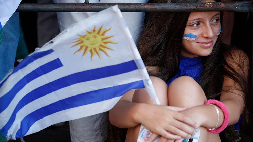 A supporter of Uruguay’s new President Luis Lacalle Pou waits for his arrival to Congress in Montevideo, Uruguay
