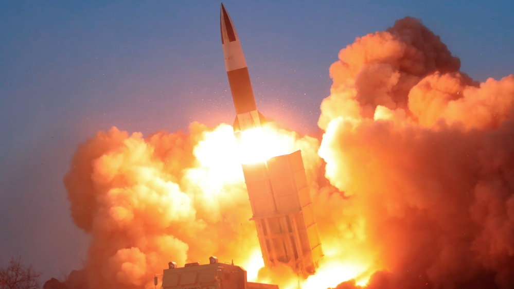 North Korean leader Kim Jong Un observes the firing of suspected missiles