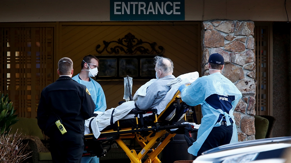 Medics wheel out a person on a stretcher from the Life Care Center of Kirkland, a long-term care facility linked to several confirmed coronavirus cases, in Kirkland, Washington, U.S. March 4, 2020. RE