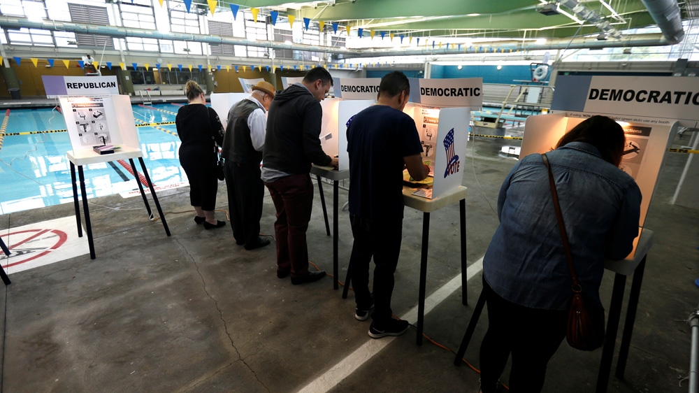 People vote on the deck of the Echo Park Deep Pool in Los Angeles, California