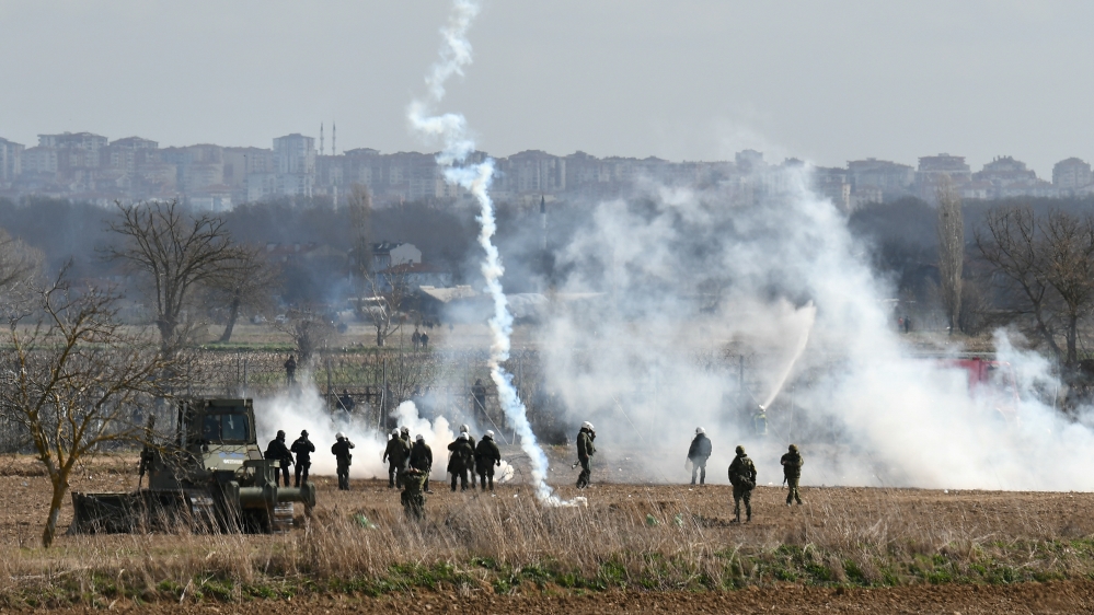 Greek riot police officers stand guard as tear gas is fired near Turkey’s Pazarkule border crossing, in Kastanies, Greece on March 7, 2020