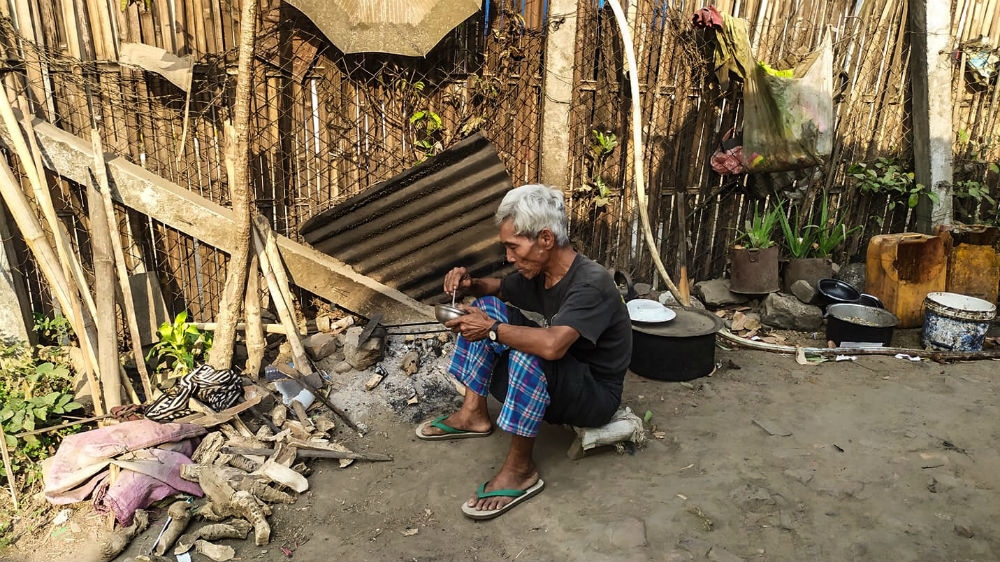 A man eats lunch in Zilun IDP camp in the Kachin State capital Myitkyina days before the camp implemented a complete lockdown on April 8