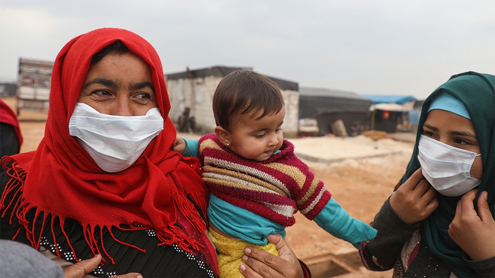 Syrian women wear face masks during an awareness workshop on Coronavirus (COVID-19) held by Doctor Ali Ghazal at a camp for displaced people in Atme town in Syria''s northwestern Idlib province, near