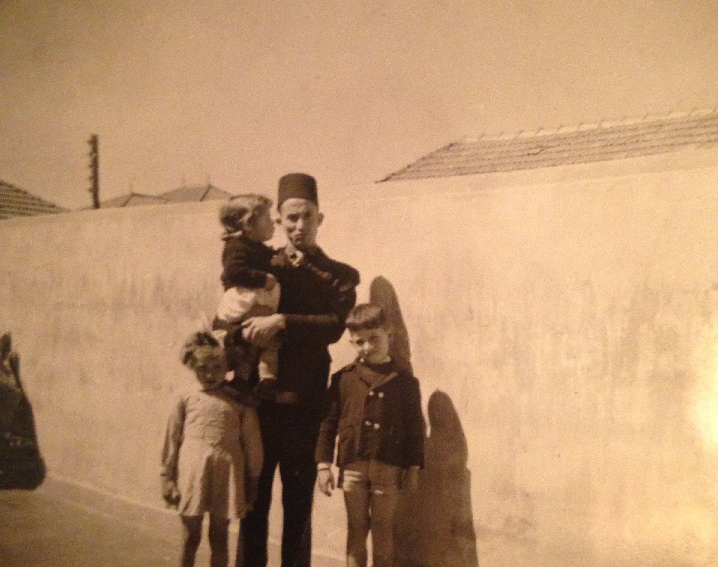 Nora’s grandfather with his children – including Nora’s father on the far right – in Miliana, Algeria in the late 1950s [Photo courtesy of Nora Belblidia]