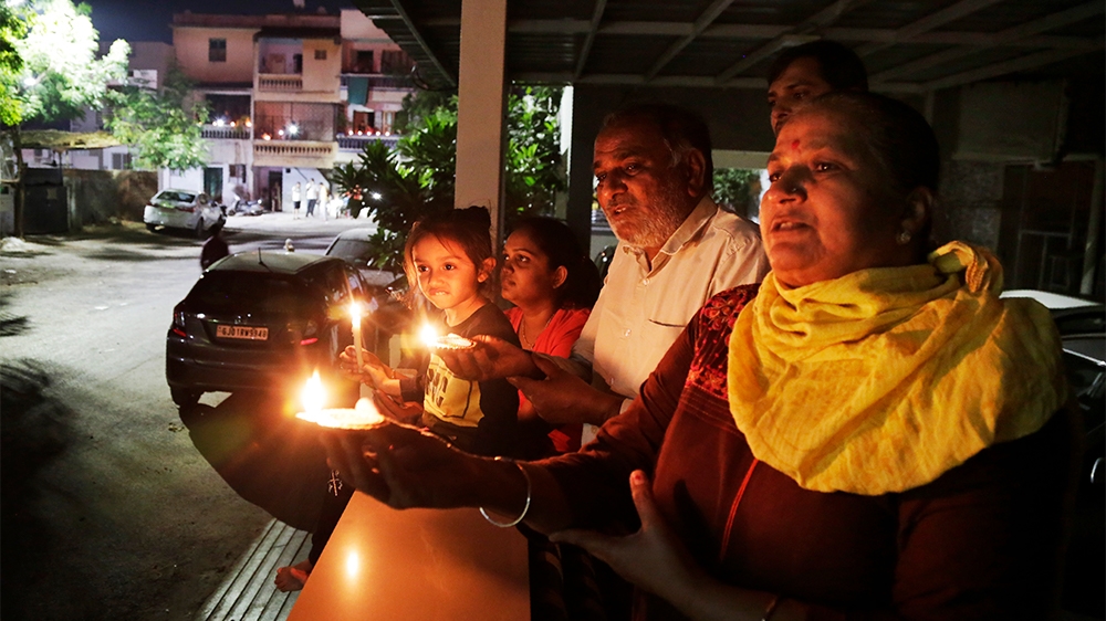 A family in Ahmedabad holds lamps to mark the country’s fight against the pandemic