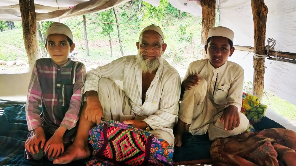 Jumman with his grandsons in their hut on a lazy afternoon in the forest