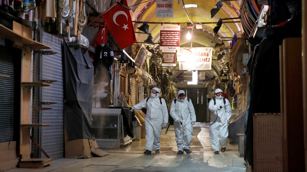 Workers in protective suits spray disinfectant at Grand Bazaar, known as the Covered Bazaar, to prevent the spread of coronavirus disease (COVID-19), in Istanbul, Turkey, March 25, 2020. REUTERS/Umit