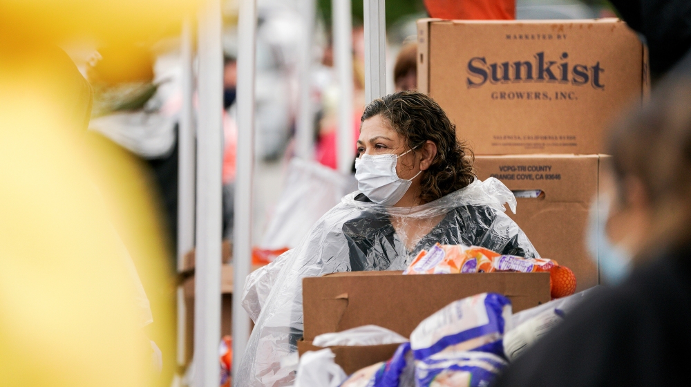 A volunteer with Los Angeles County Federation of Labor, AFL-CIO, hands out boxes of food to LAX workers in the parking lot of The Forum during the outbreak of the coronavirus disease (COVID-19), in I