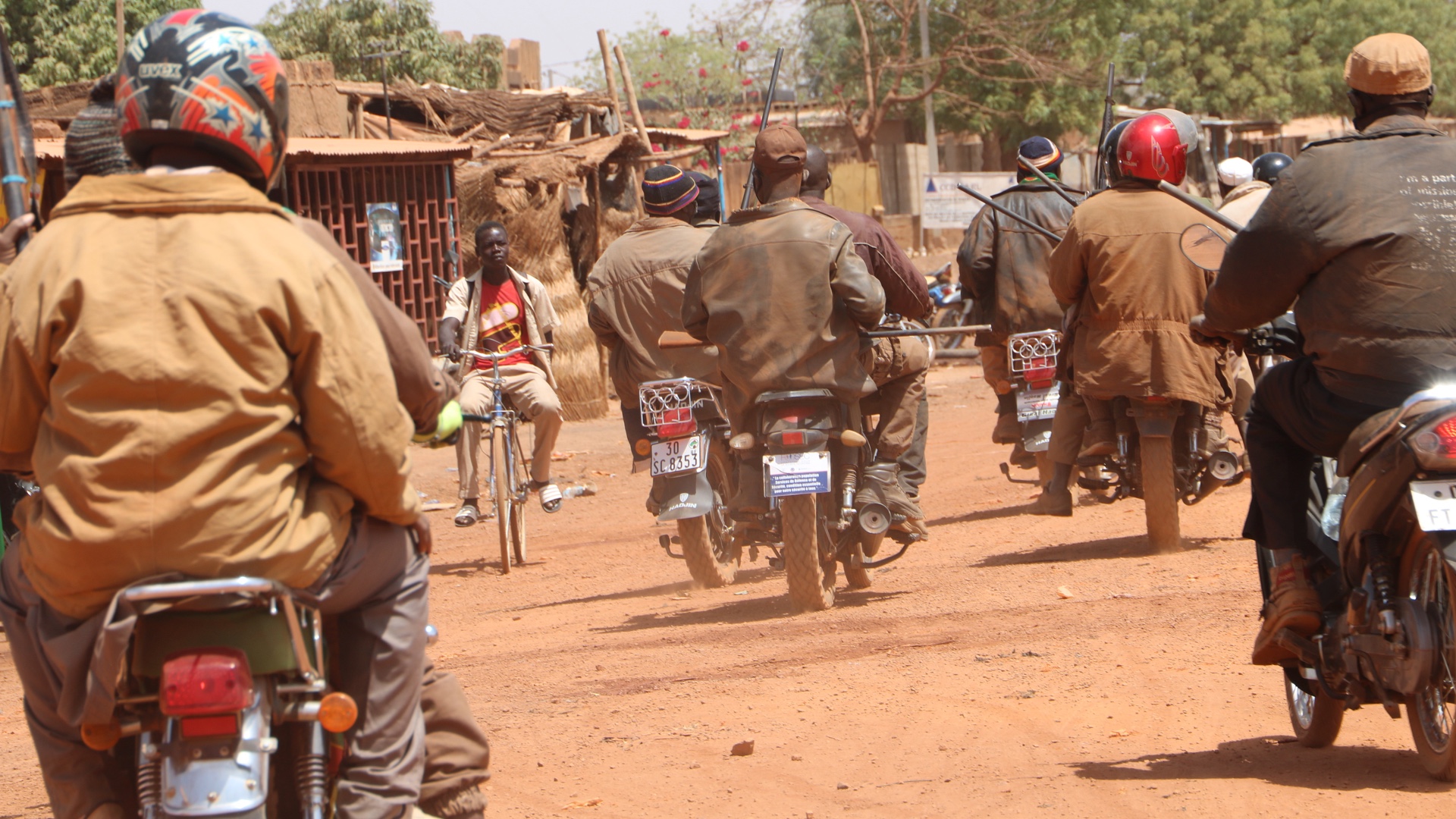 Members of a self-defence militia ride through Boulsa on their way to see their chief