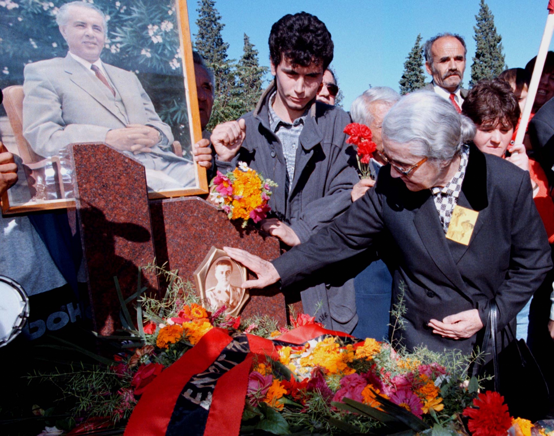 Nexhmije Hoxha cleans the photograph at her husband Enver’s tomb in Tirana in 1998