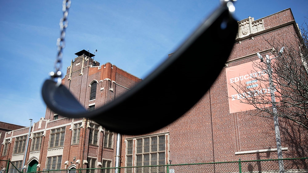 A swing sits empty on a playground outside Achievement First charter school in Providence, Rhode Island