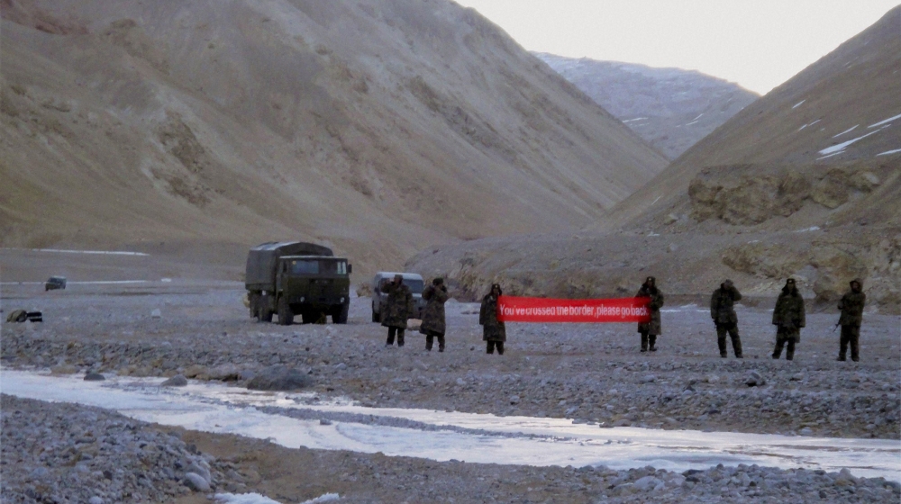 In this May 5, 2013 file photo, Chinese troop hold a banner which reads,