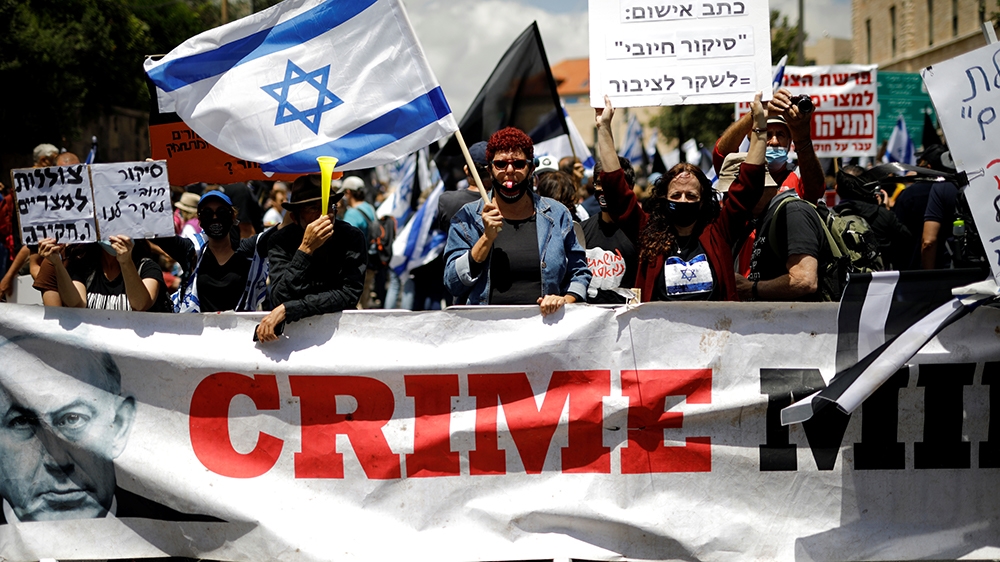 Protesters demonstrate against Netanyahu just before his corruption trial opens