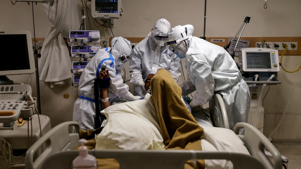 Medical workers wearing personal protective equipment (PPE) take care of a patient suffering from the coronavirus disease (COVID-19), at the Intensive Care Unit (ICU) of the Max Smart Super Speciality