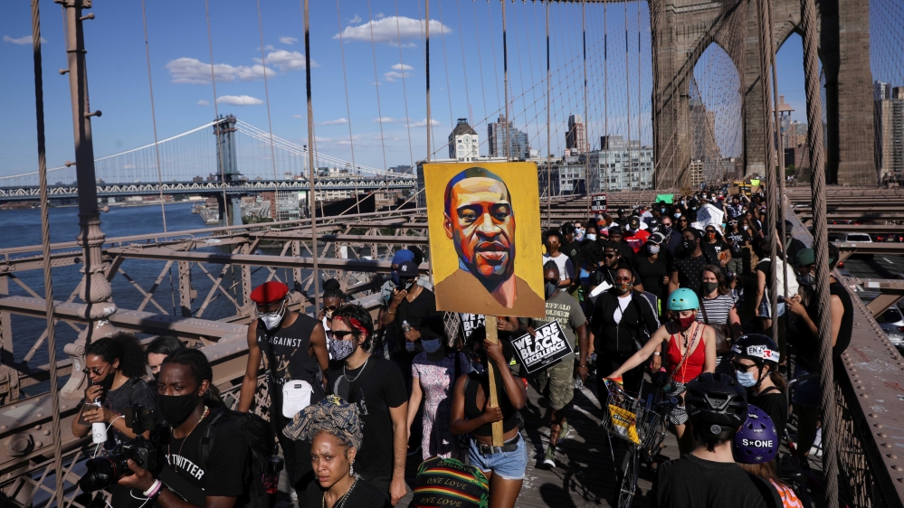 Demonstrators hold signs