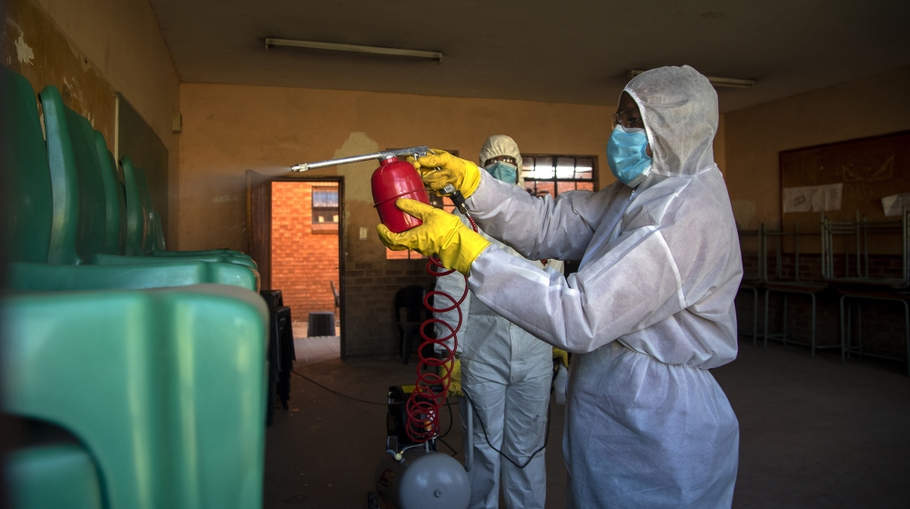 Disinfection team disinfect a classroom at Ivory Park Secondary School east of Johannesburg, South Africa, Thursday, May 28, 2020, ahead of the June 1, 2020, re-opening of Grade 7 and 12 learners to s