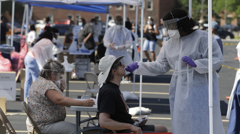 David Webb is tested for COVID-19 by Shaleea Mason after Webb attended a non-violent sit in at the Statehouse in Indianapolis, Saturday, June 6, 2020. The demonstration was over the death of George Fl