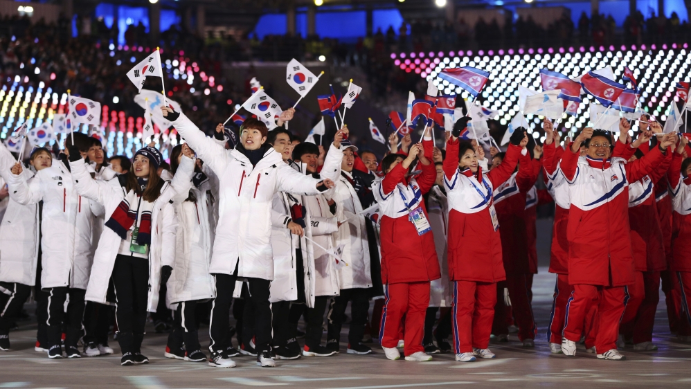 North and South Koreans wave flags during the closing ceremony of the 2018 Winter Olympics in Pyeongchang, South Korea