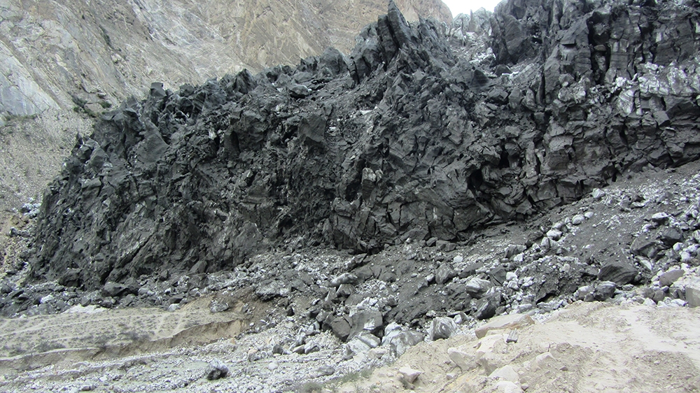 The Shishper Glacier, a black mass of ice and debris, advances in Hassanabad ravine, Hunza district, Pakistan