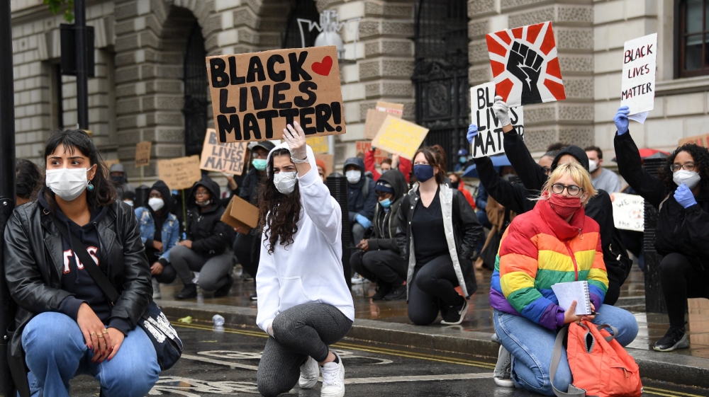Demonstrators hold placards during a Black Lives Matter rally in Parliament Square in London