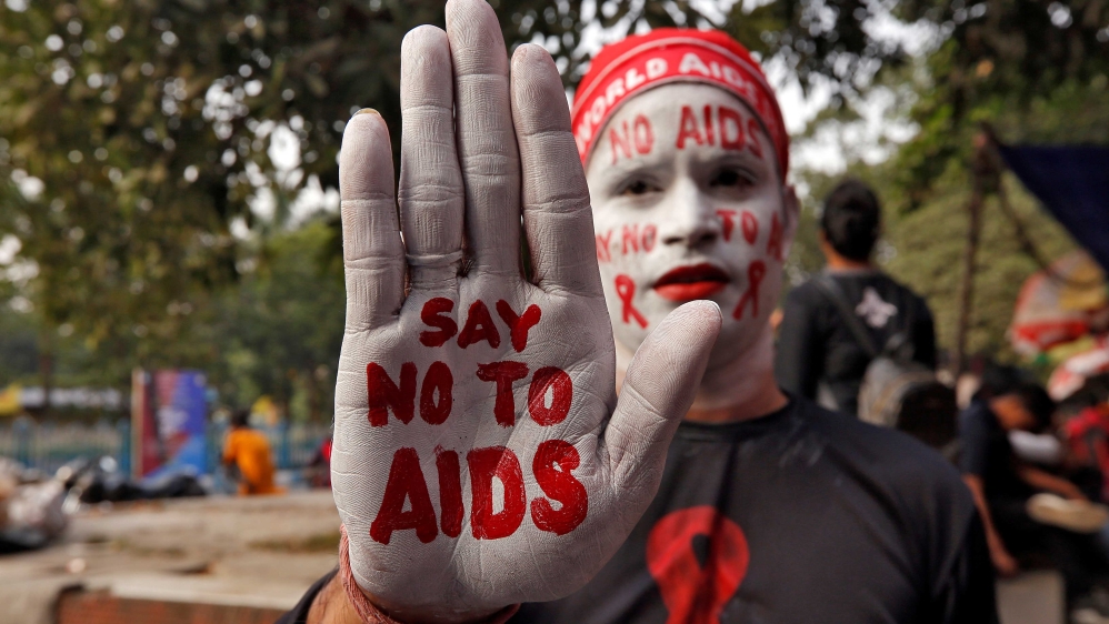 A man holding up his hand-painted with the words, ‘say no to AIDS’ during an HIV/AIDS awareness campaign on the eve of World AIDS Day in Kolkata, India