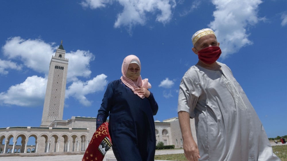 Tunisians wearing protective masks leave after attending the first Friday prayer following a 3-months suspension due to the novel coronavirus, at the Malek Ibn Anas Mosque in Carthage