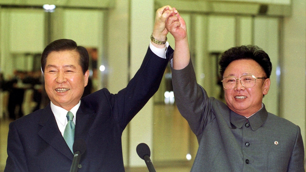 In this June 14, 2000 photo, South Korean President Kim Dae-jung, left, and North Korean leader Kim Jong Il raise their arms together before signing a joint declaration at the end of the second day of a three-day summit in Pyongyang, North Korea.