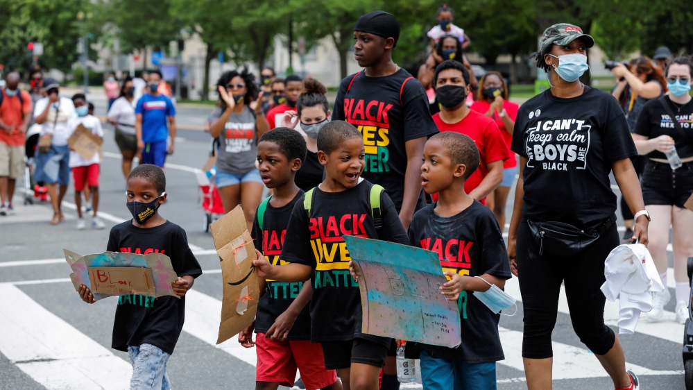 Participants march towards the Washington Monument during the Black Mamas March as racial inequality protests continue in Washington, DC, the US
