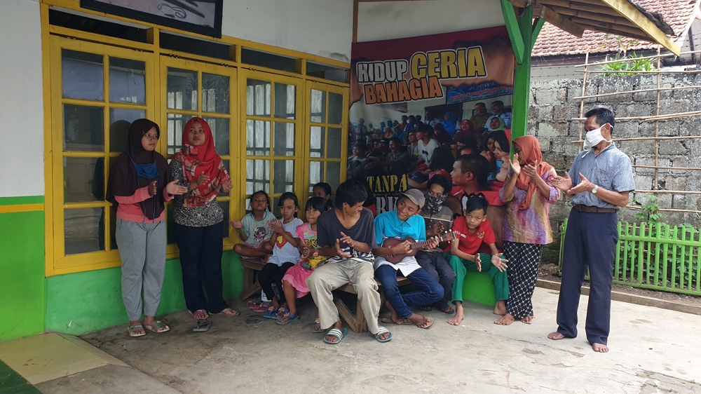 Children gather outside the shelter in Depok in West Java. The building offers a place of refuge
