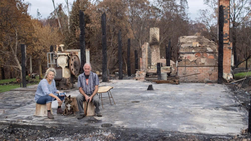 Gabrielle Powell with her husband in the ruins of their home