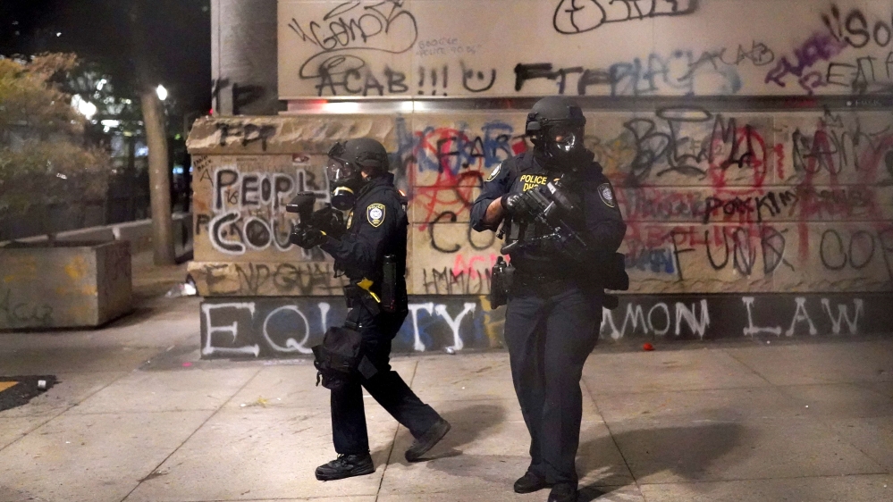 Federal police guard the entrance to the Mark O Hatfield US Courthouse in Portland, Oregon