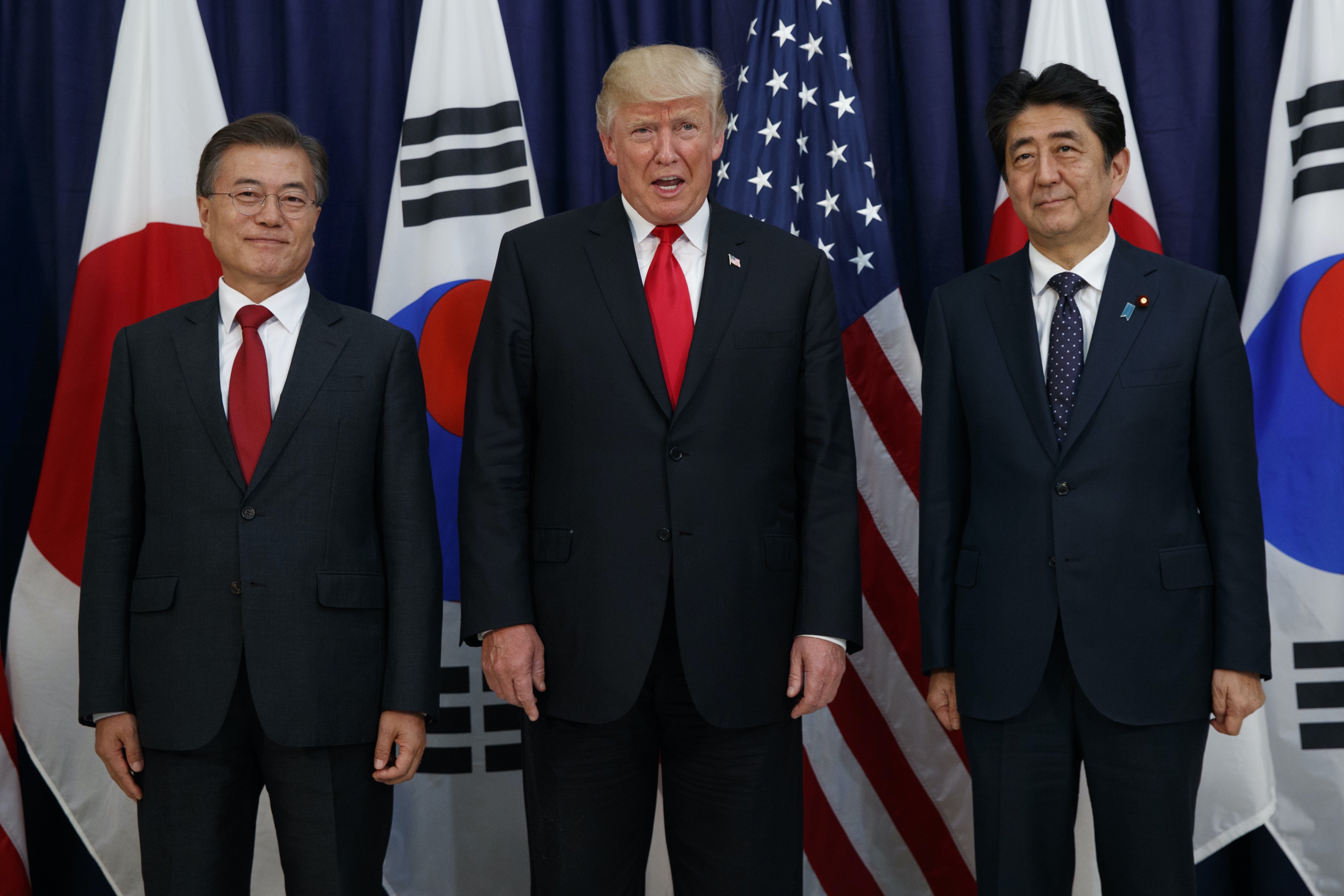 US President Donald Trump flanked by Japan’s Prime Minister Shinzo Abe (right) and South Korea’s President Moon Jae-in (left) in 2017