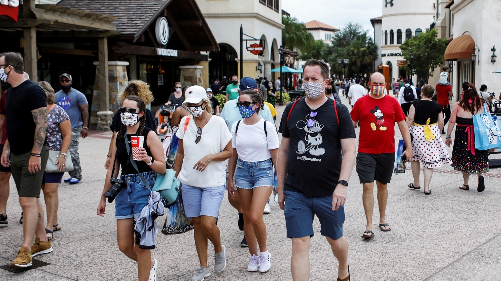 Disney Springs shoppers wear face masks and Disney-themed clothing while Walt Disney World conducts a phased reopening from coronavirus disease (COVID-19) restrictions in Lake Buena Vista, Florida, U.