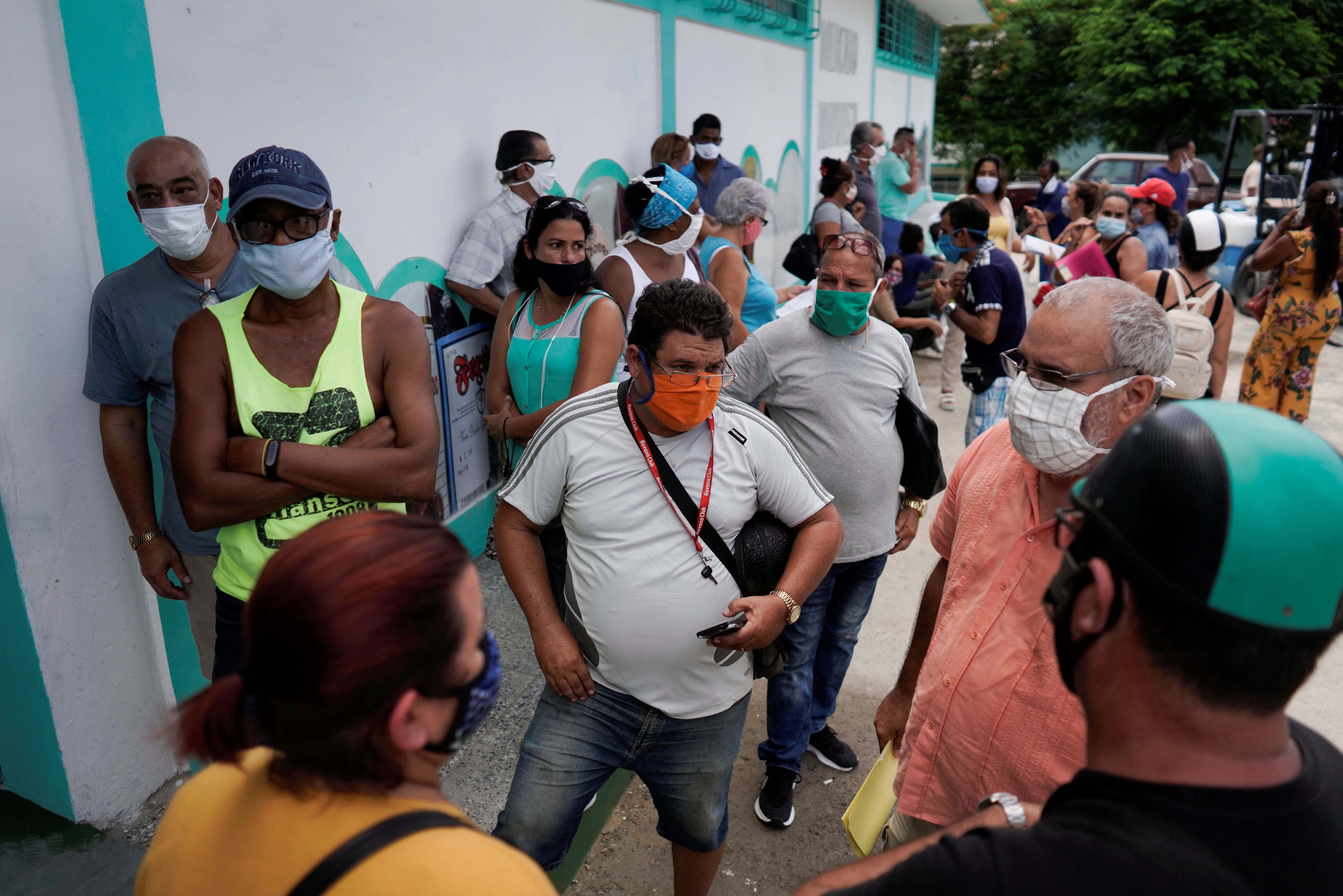 People wait at the first wholesale outlet for private eateries in Havana, Cuba