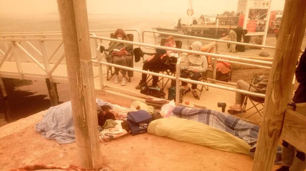 People from Mallacoota took shelter by the lake as they waited for the fires to pass
