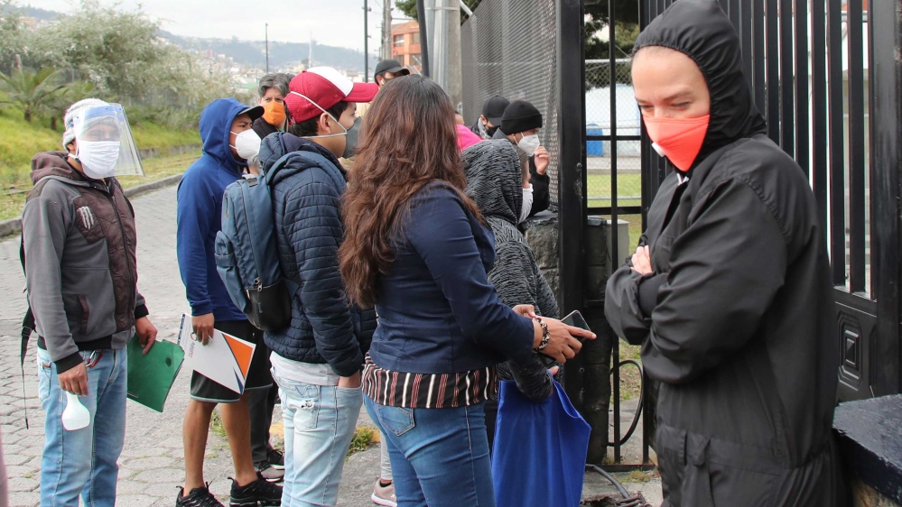 People waiting in line to get COVID-19 tests, outside a health clinic in Quito, Ecuador