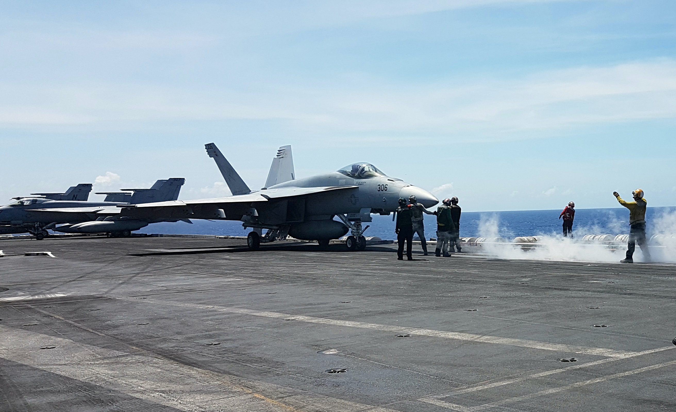 An F18 fighter prepares to take off from the flight deck of the USS Theodore Roosevelt while transiting the South China Sea, a crucial waterway that is the subject of overlapping territorial claims by China and several smaller Asian nations