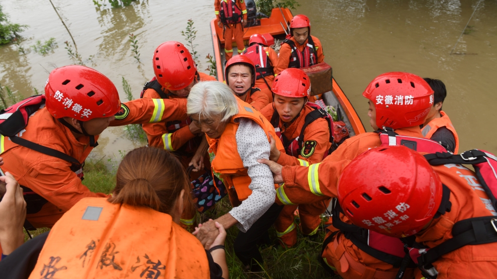 Rescue workers evacuate a flood-affected resident near Wangjiaba dam on the Huai River in Funan