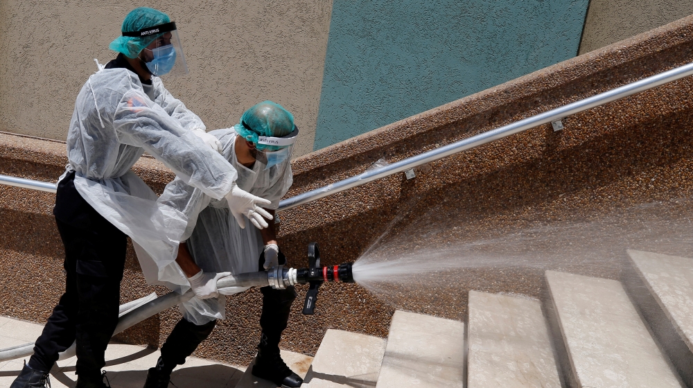 Members of Palestinian security forces loyal to Hamas spray disinfectants during a simulation exercise for preventing the spread of the coronavirus disease (COVID-19), in Gaza City July 18, 2020. Pict