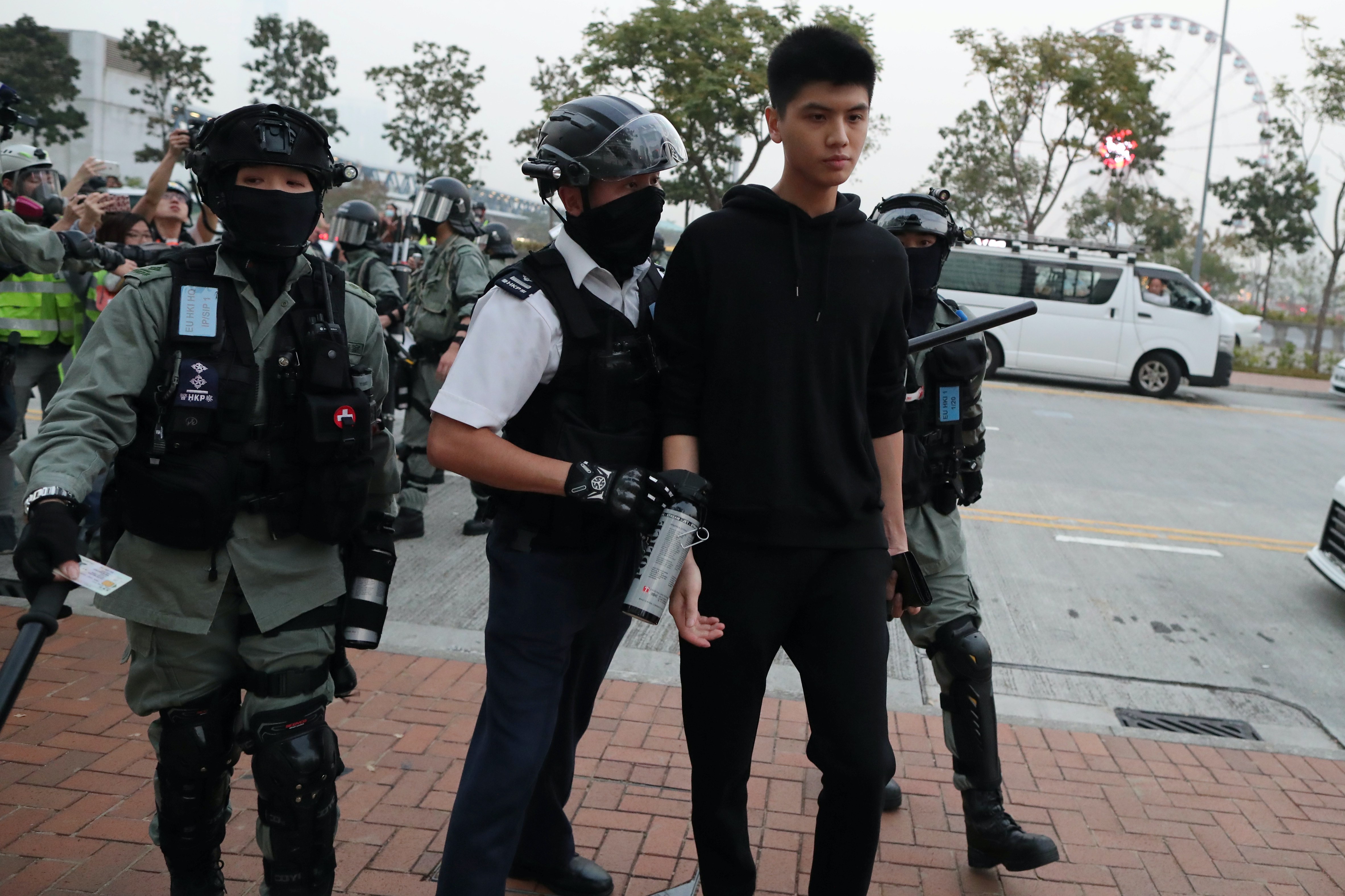 Police detain a Hong Kong protester at a rally in support of the human rights of Xinjiang Uighurs in Hong Kong, China last December