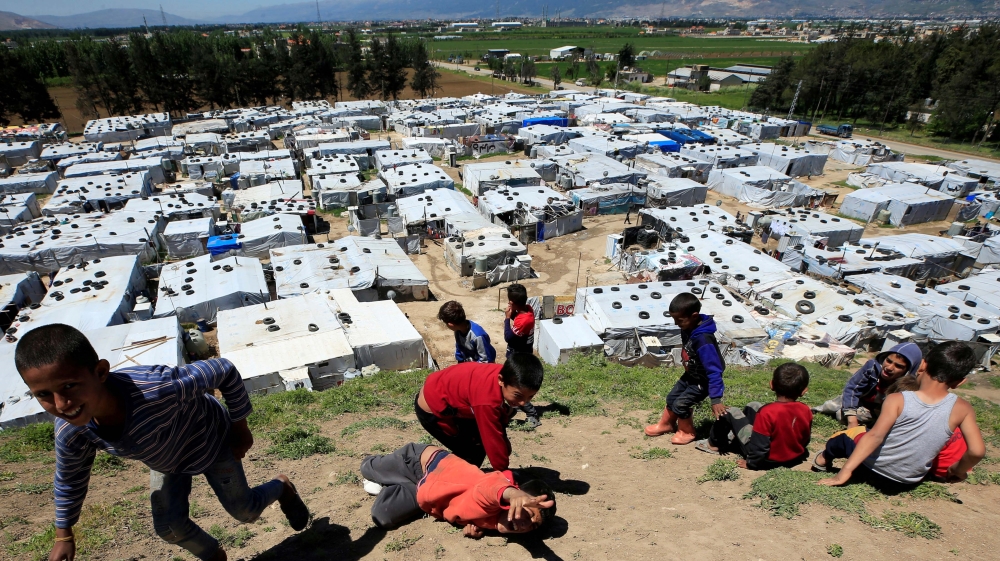 Syrian refugee children play together, as Lebanon extends a lockdown to co