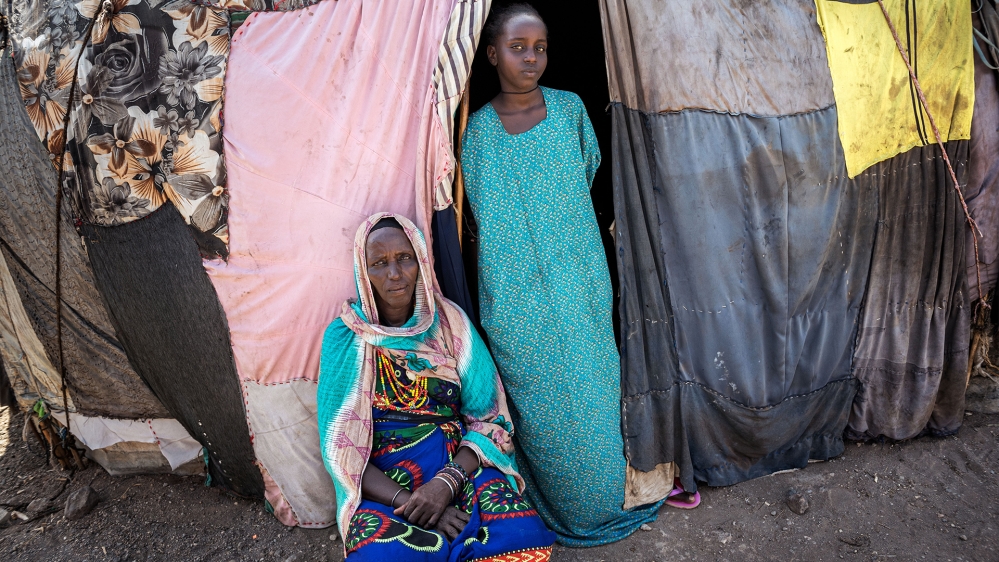 Gumato and her mother in front of their hut