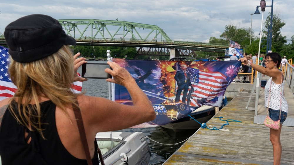Onlookers watch as ‘MAGA boaters’ prepare to embark on their pro-Trump boat rally in Brewerton, New York