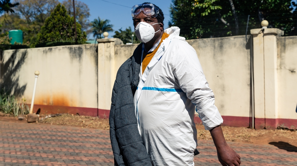 Zimbabwean journalist and documentary filmmaker Hopewell Chin''ono arrives at his home in police custody as police conduct a search of his offices in Harare on July 21, 2020, a day after he was arrest
