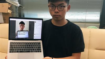 Hong Kong Pro-democracy activist Joshua Wong shows his Twitter post calling for a boycott of Disney’s Mulan